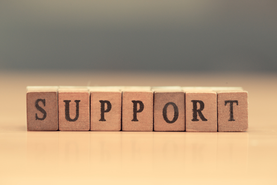 Support. word written on wood block